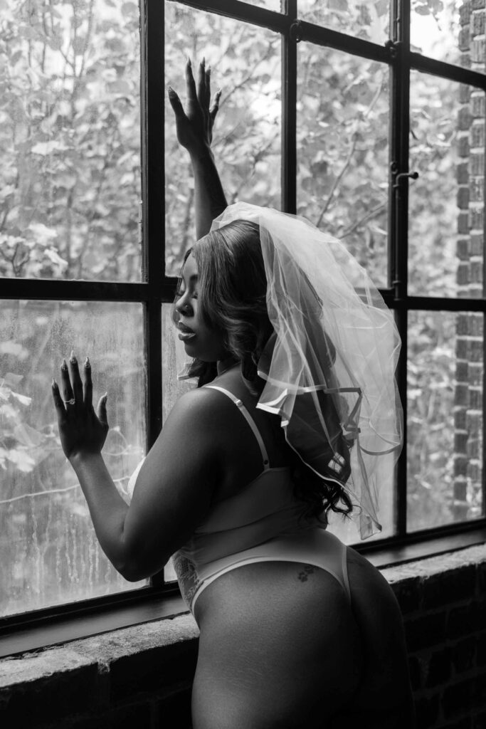 woman poses in her bridal veil during her boudoir photoshoot in Atlanta
