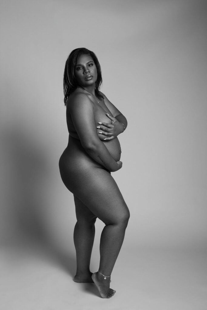 beautiful mom-to-be poses for her maternity boudoir photographer for a portrait